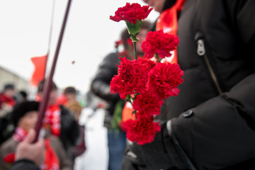 Memory of the dead. Red carnations on a gravestone