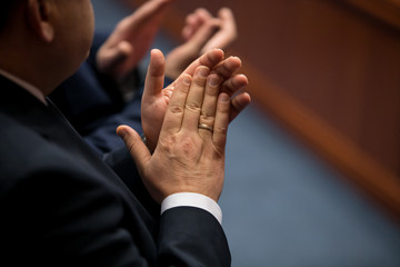 Close-up of business people clapping hands. Business seminar concept