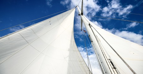 View upwards to the mast of a sailboat on a summer day
