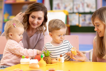 Babies playing with toys in montessori school