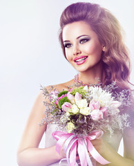 Happy beautiful girl with flowers in hands