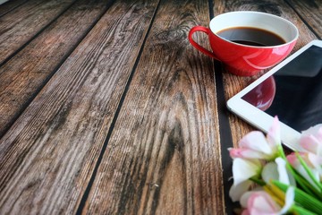 Close up of red coffee cup on wooden table.