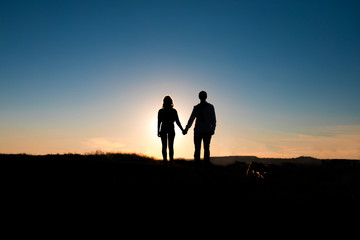 Fototapeta na wymiar Romantic couple hug at sunset on background.