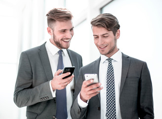 two employees using their smartphones on a work break