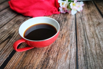 Close up of red coffee cup on wooden table.