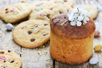 Traditional russian Easter bread kulich paska and Easter cookies on wooden table