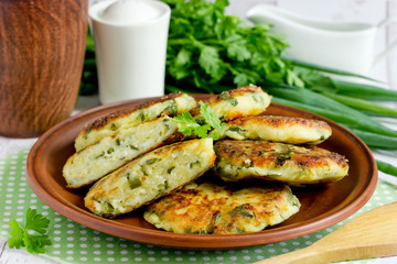 Cottage cheese pancakes or syrniki with herbs green onion and parsley