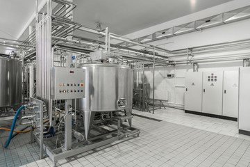 general view of the interior of a milk factory. equipment at the dairy plant