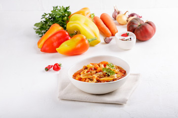 Stewed vegetables. Vegetable ragout of sweet pepper, carrot, onion, tomatoes. Vegetarian food.