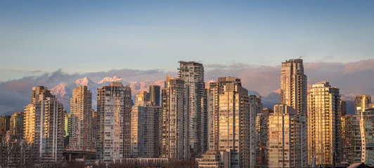 Downtown Vancouver at sunset with the mountains in the background.