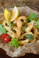 Shrimp, squid rings and other seafood deep-fried in batter.