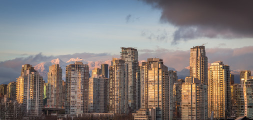 Downtown Vancouver at sunset with the mountains in the background.