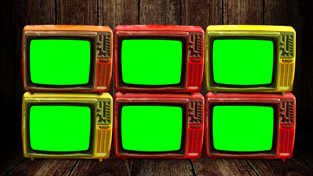 Group of retro television with green screen at wooden floor and wall background