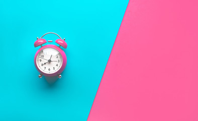 Colorful alarm clock on pastel background.Minial flat lay
