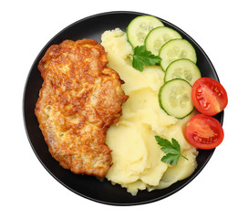 Mashed potatoes with schnitzel on black plate isolated on white background. top view.