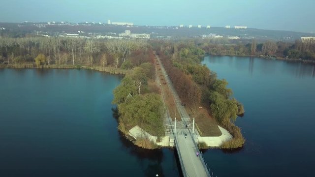 Aerial footage over Echo Park Lake, Kishinev, Moldova republic of. View of lake and smille bridge.