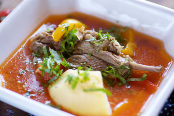 Delicious hearty soup with beef, lamb or pork on the table in the restaurant.