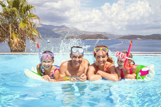 Portrait of big family  swimming in  pool on sea resort