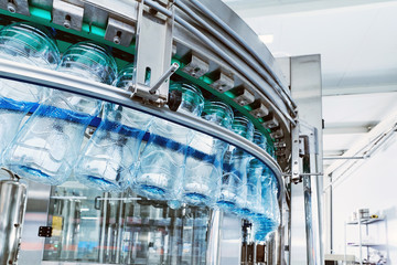 Closeup Water bottling line for processing mineral water