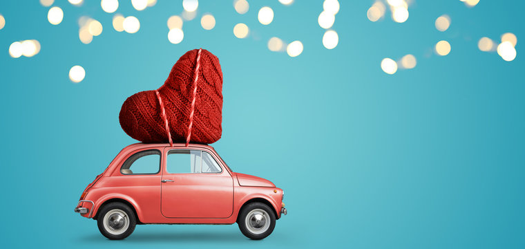 Living coral retro toy car delivering craft heart for Valentine's day on blue background