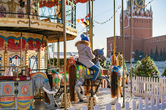 photo of colorful carousel with children in warm sunny spring day b