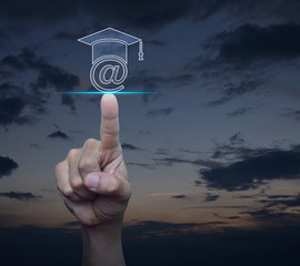 Hand pressing e-learning flat icon over sunset sky, Business study online concept