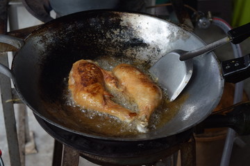 Fried chicken calves in an iron pan.
