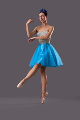 View from side of ballerina dancing on isolated background