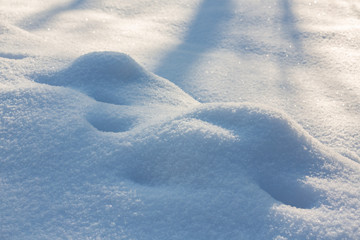 Blue snowflake background, overlay. Snowdrift. Rough snow texture pattern. Snow texture background with copy space. Snowflakes sparkle in the sun in the cold.