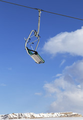 Ski-lift and blue sky with clouds at winter day