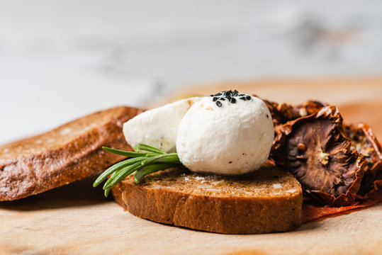Fresh labne round cheese on cereal brown bread
