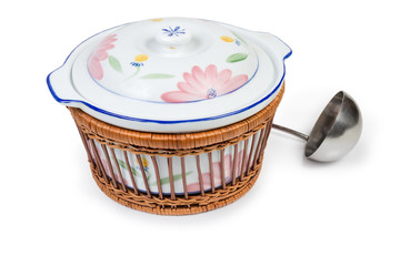 Vintage ceramic tureen in wooden basket and stainless steel ladle