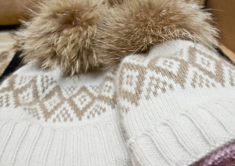 Fototapeta na wymiar Bright knitted hat with fluff
