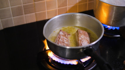 cordon blue fried in oil in a frying pan. Chicken cordon bleu frying in hot oil, battered in bread crumbs
