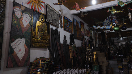 Hindu and Buddhist wooden carving. souvenir shop selling souvenirs and handicrafts of Bali at famous Ubud Market, Indonesia