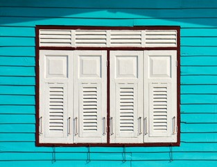 white wood window at blue house