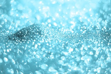 light blue glossy copper sand mountain made of glitters - bar concept with bokeh texture - wonderful abstract photo background