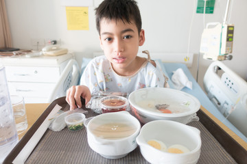 Little boy's bored from sick hospital food