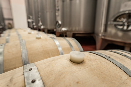 Detail of a oak barrel inside a winery