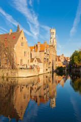 Fototapeta premium Rozenhoedkaai canal (Quai of the Rosary), and Belfort van Brugge’s Belfry Tower. Typical view of Bruges (Brugge), Belgium.