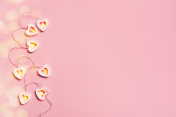 Fototapeta premium Tender pink background with heart lights on pink