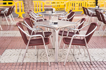 Cafe, coffee shop, tavern and restaurant concept - Outdoor street cafe tables ready for service.