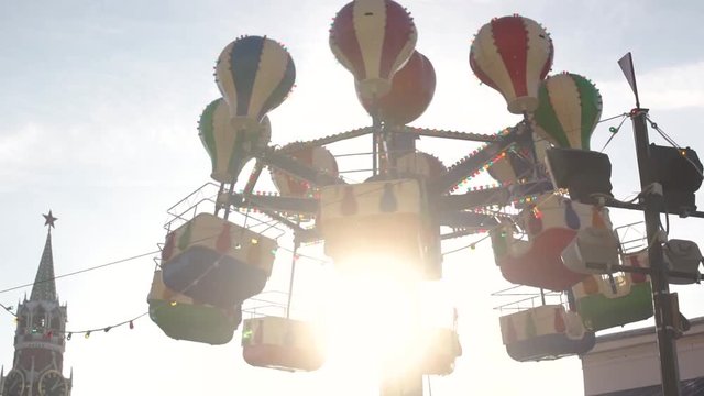 Ferris wheel spinning at sunset. The magical attraction.