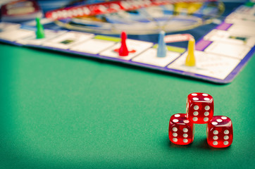 several red dice for board games on a green background