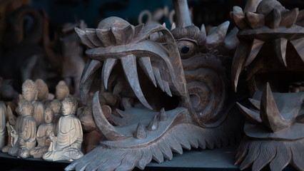 Hindu and Buddhist wooden carving. souvenir shop selling souvenirs and handicrafts of Bali at famous Ubud Market, Indonesia