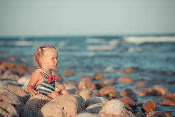 Adorable girl walking along beach
