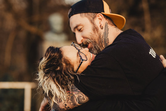 Happy young couple hugging in forest