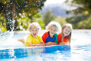 Kids in swimming pool. Children swim. Family fun.