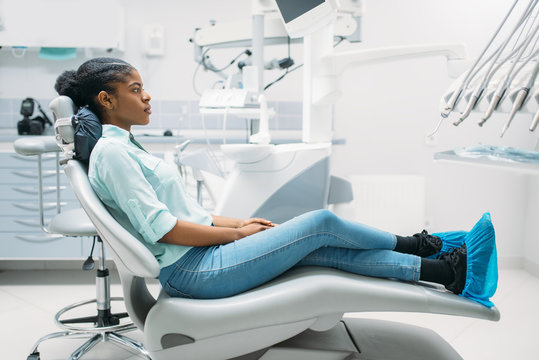 Female patient on chair, visit in dental clinic