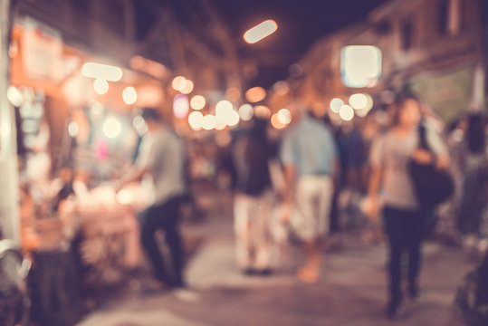Abstract blur image of flea market and people at night with bokeh for background usage.